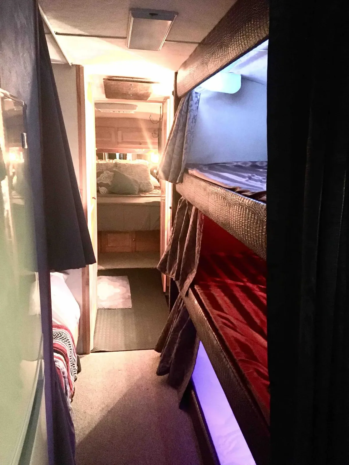 Three genuine driver-side bunks along the aisle inside the vintage Eagle tour bus