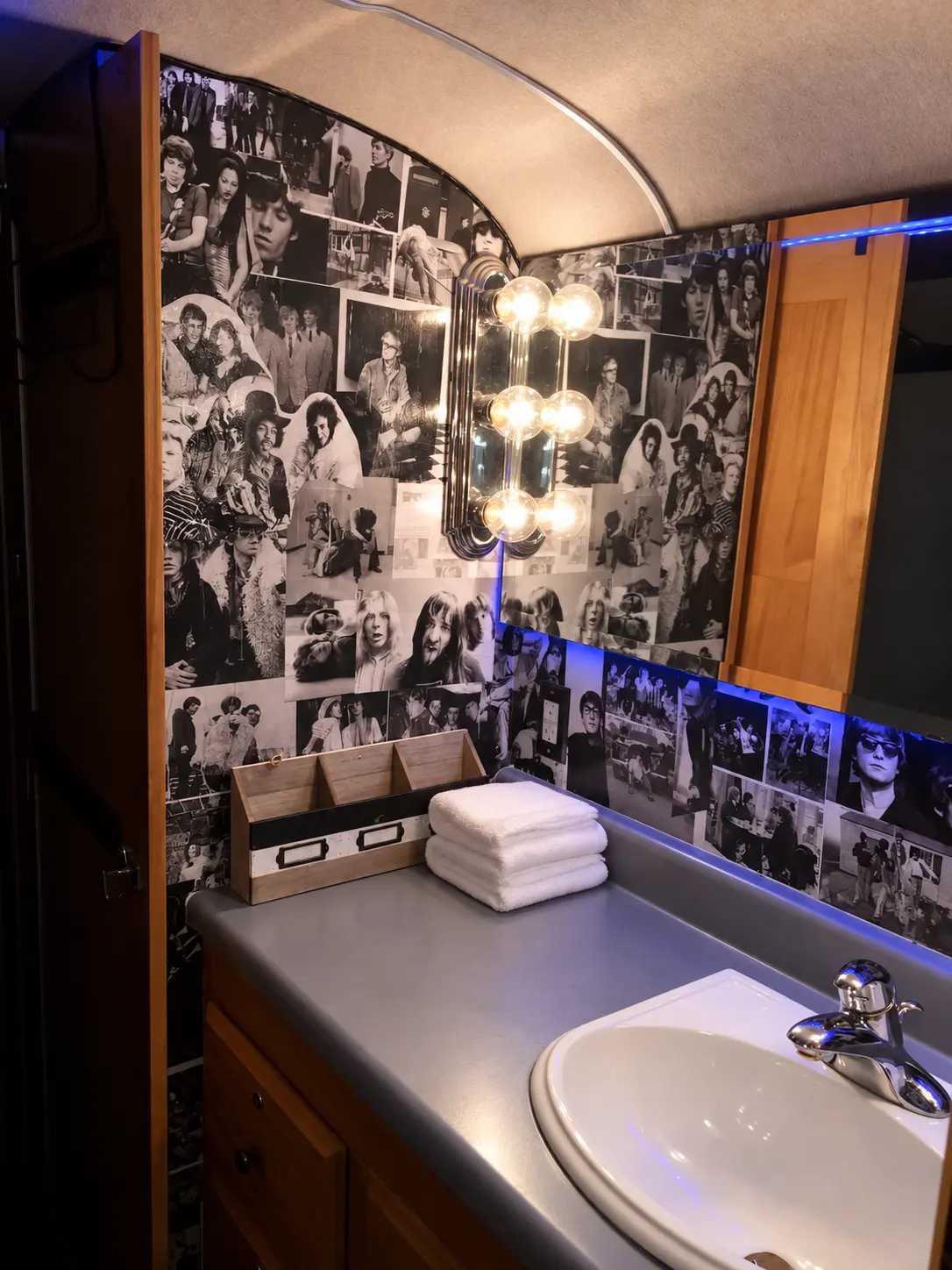 Tour bus vanity with sink, mirror and rock-and-roll photo wall