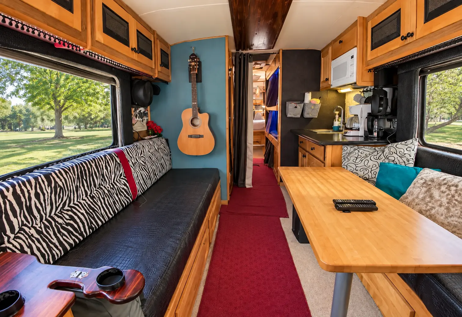 Daylit lounge and dining area inside the vintage Eagle tour bus